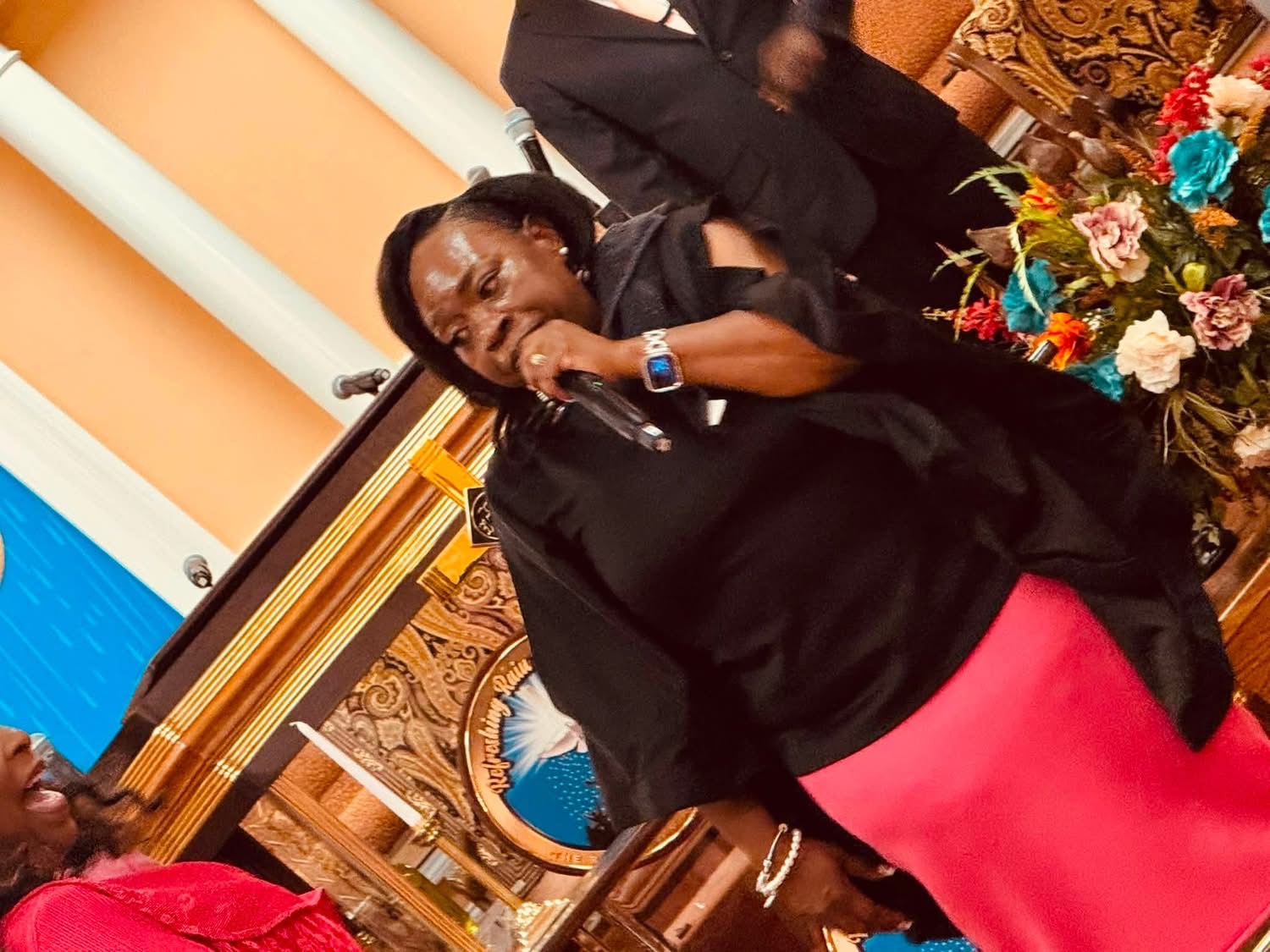 Evangelist Teresa ministering with a microphone