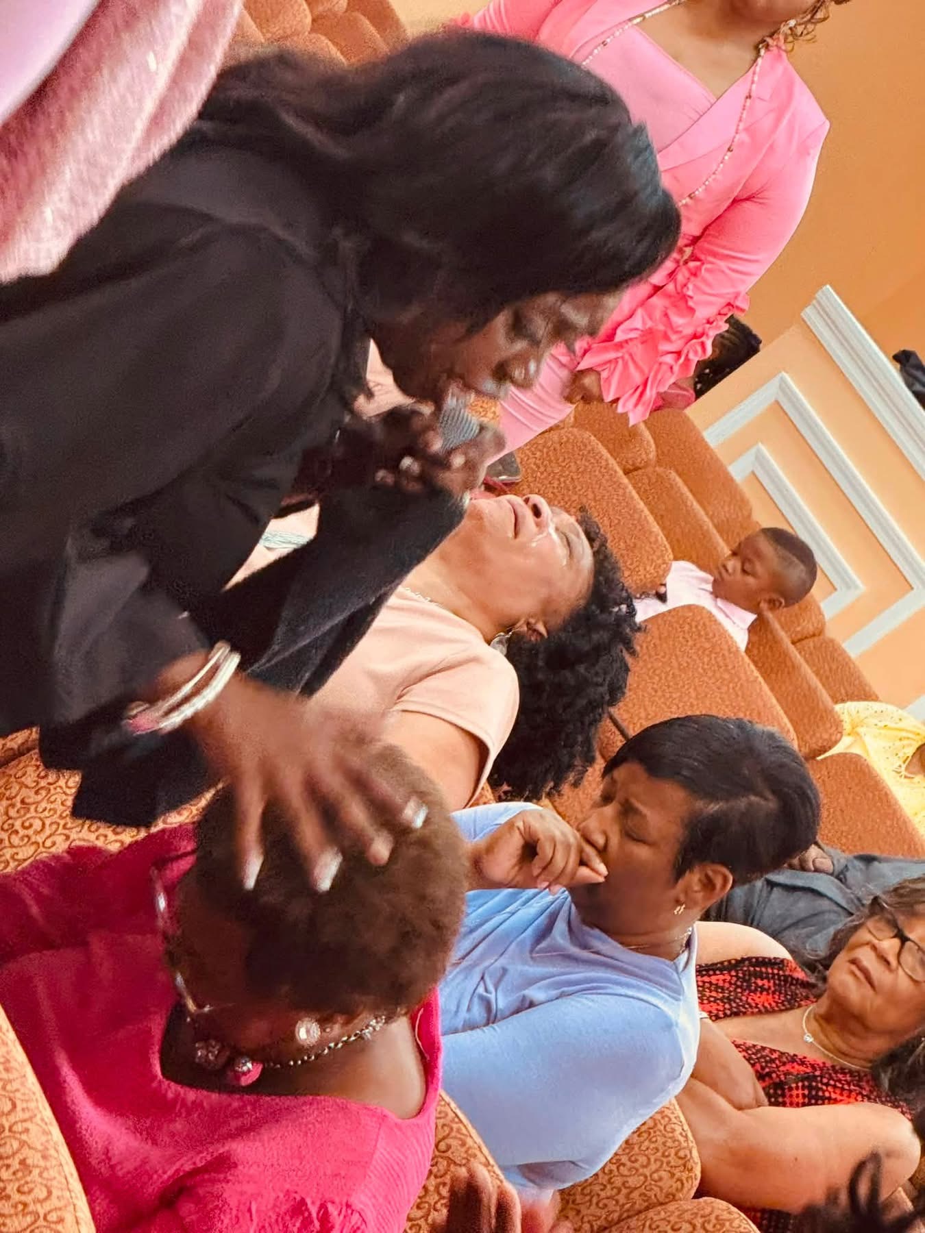 Evangelist Teresa praying with worshippers